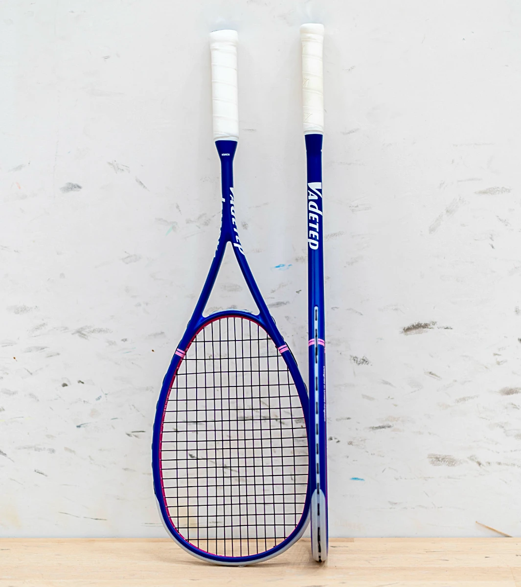 Vadetep 105 squash racket leaning against wall