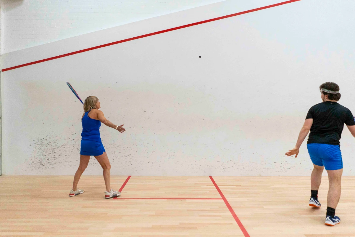 Two players in a squash match with Vadetep squash rackets