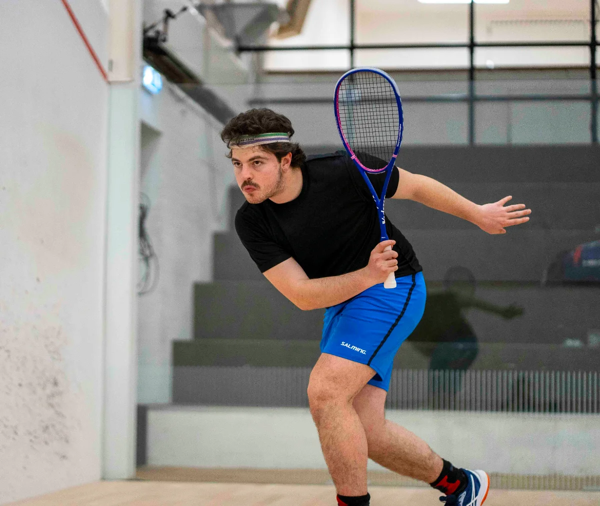 Man running for a squash shot with Vadetep squash racket